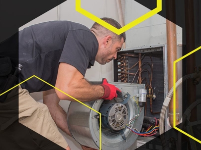 Tech installing a part into an HVAC system