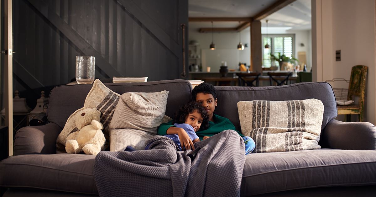 Father and son cuddling on their couch